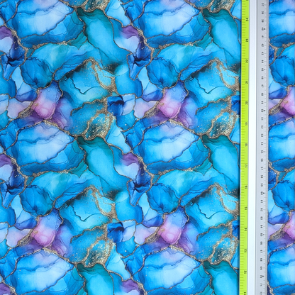 Blue and purple marbled fabric with a ruler for scale